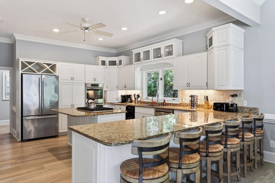Spacious kitchen with a gas stovetop and barstool seating at the island.