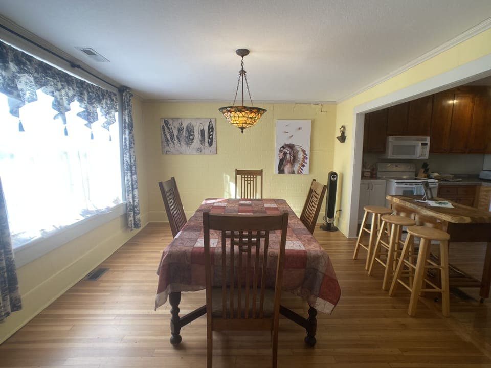 Open dining room with kitchen, large windows view downtown Everett Street. 