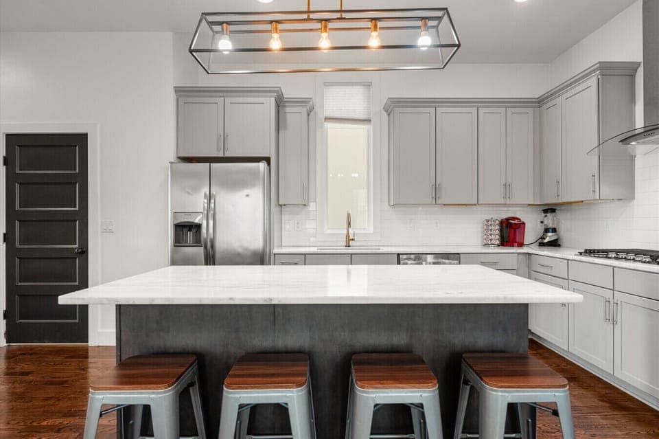 A large quartz island with plenty of counter space — everything your group needs to eat, drink, and get ready for Broadway.