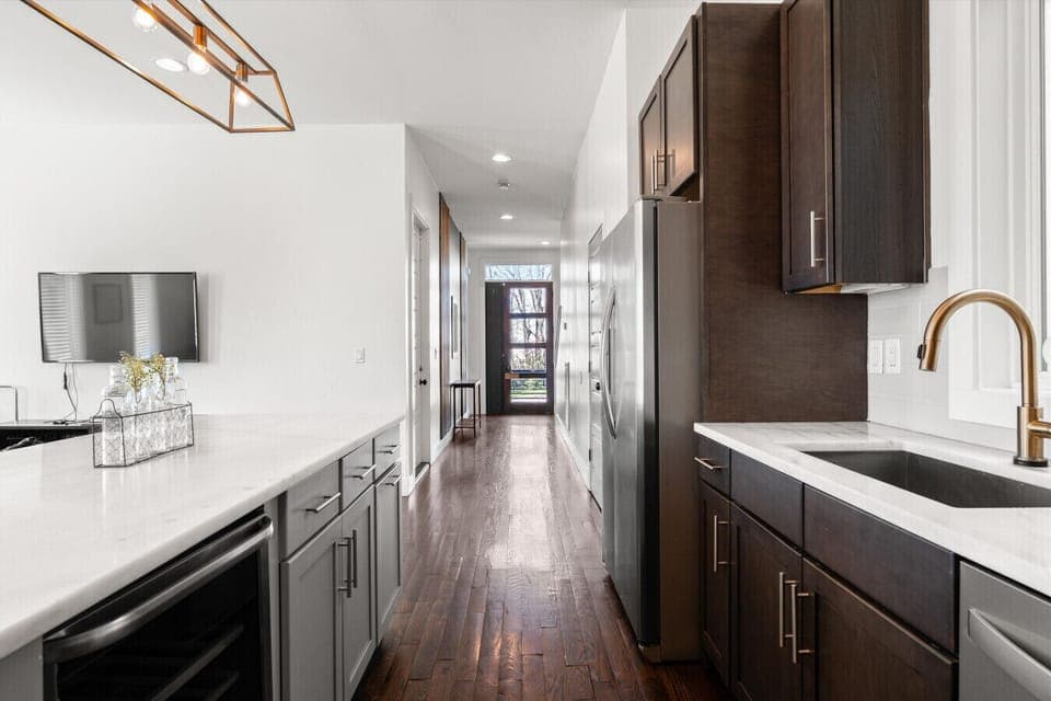 Step inside and feel it instantly — warm wood accents, soaring ceilings, and a stunning sight line straight through to the kitchen.