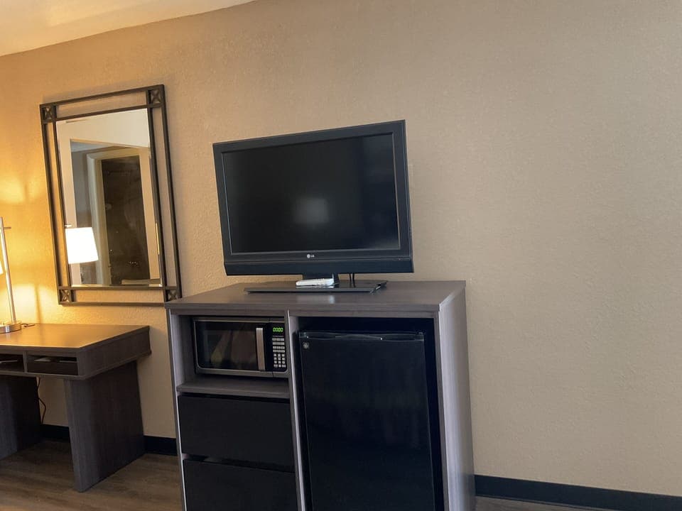 Premium bedding, desk, laptop workspace, blackout drapes