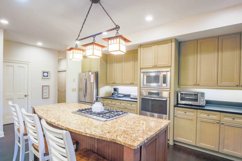 The kitchen features a gas cooktop, oven, microwave, refrigerator, drip coffee maker and toaster oven.