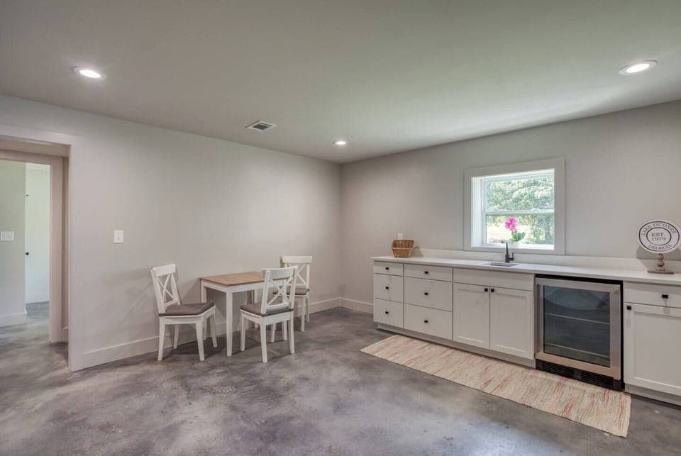 Access to the patio, mini fridge, kitchen essentials, mini dining set, coffee maker with essential coffee pods, and direct lake access.