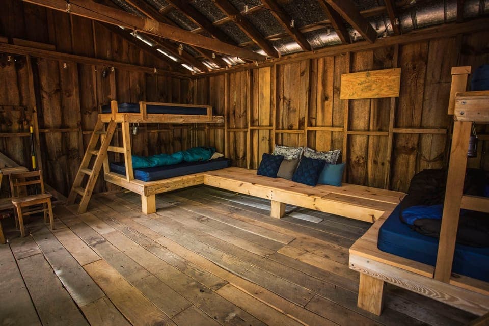 Two bunk beds and a large couch/bed in the middle