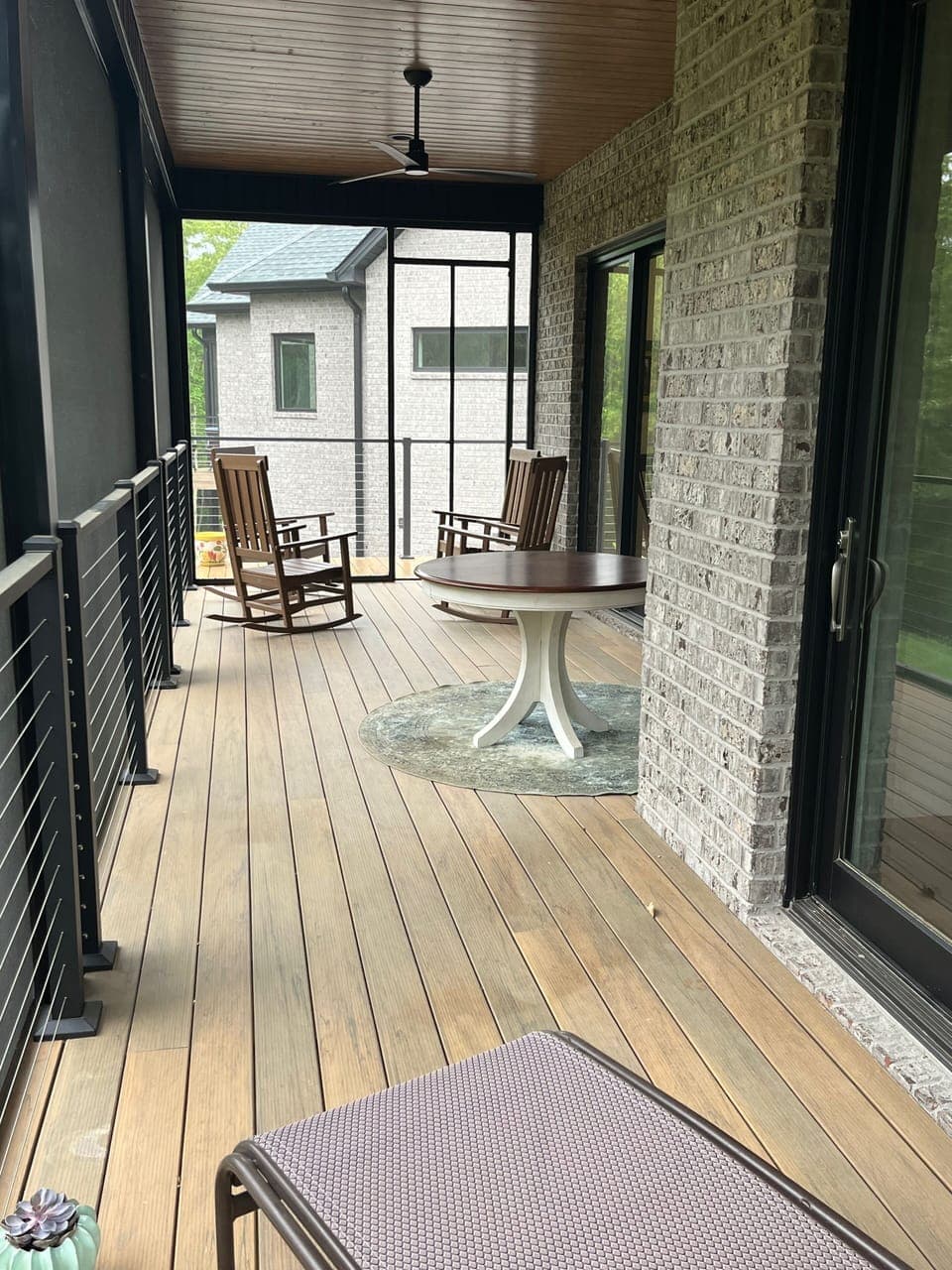 Screen porch extends the full length of the back of the Cottage.  View from BR. 