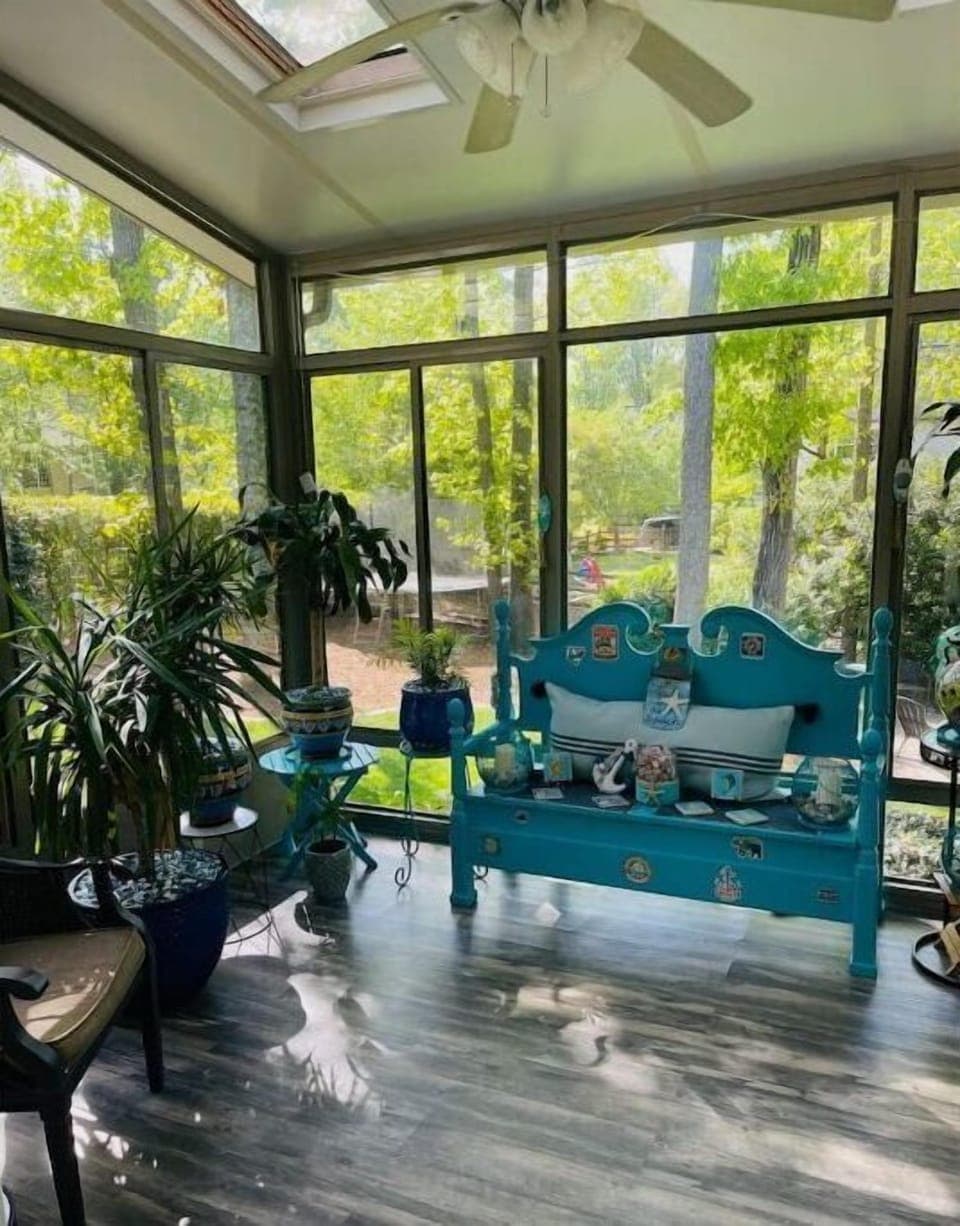 Full glass sunroom with a great view of private/wooded backyard. 