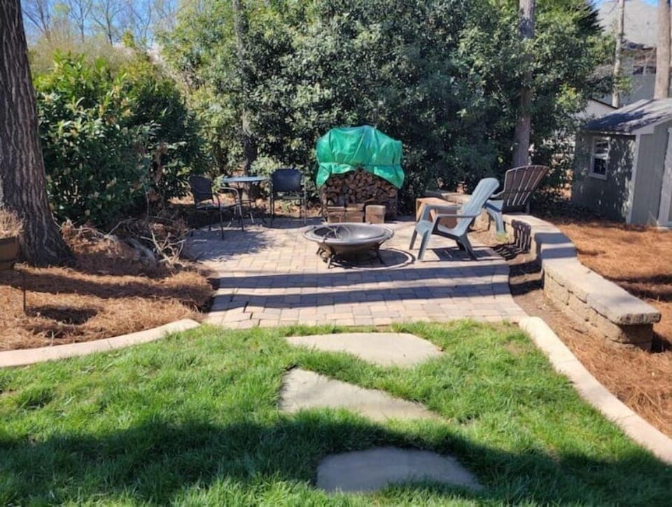 14"x14" paver patio with firepit/firewood and seating wall.