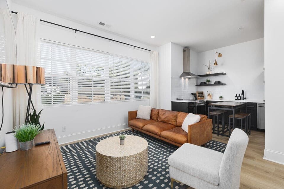 Our cozy living room is a great space to relax, with a comfortable leather couch, lots of natural light, and a Smart TV with all the streaming apps.