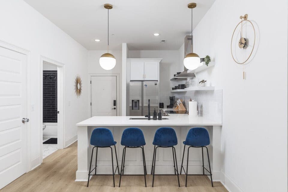 Seating for 4 at the kitchen counter off of the living room. Our kitchen is fully stocked with pots, pans, a Keurig, and premium appliances.