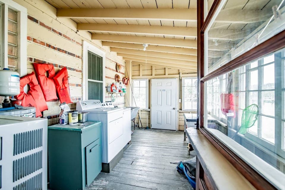 The washer and dryer are on the back porch, which leads to the dock