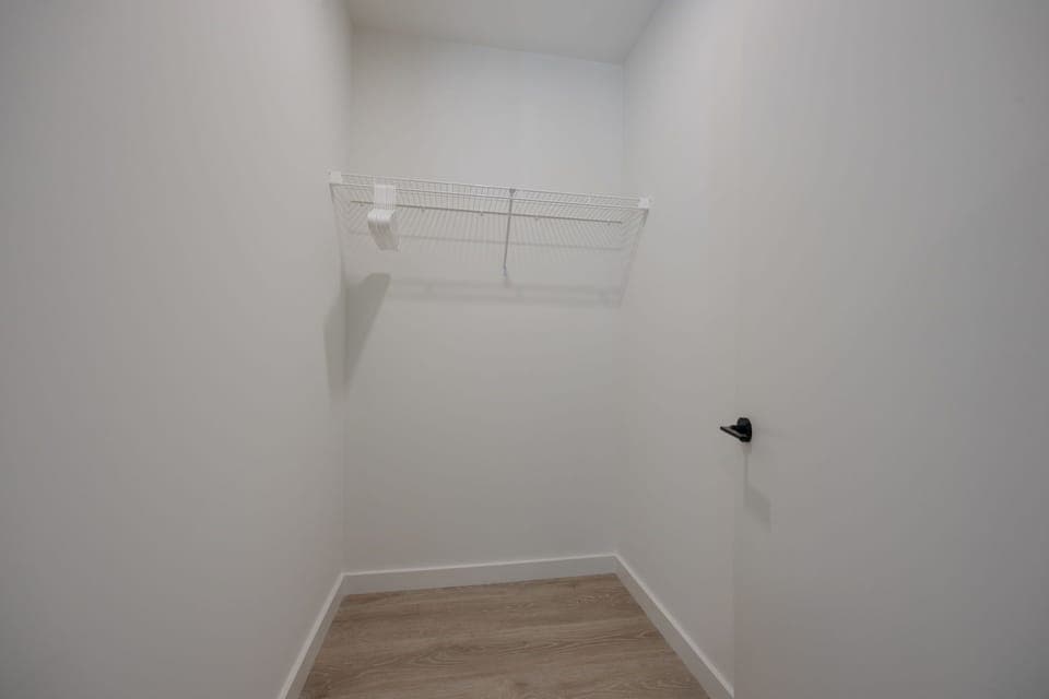 3rd bedroom features a King bed with designer furnishings and access to the balcony facing the outdoor pool.