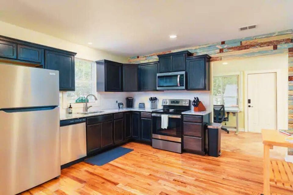Full kitchen with dishwasher, microwave and stunning hardwoods. Electric stove.