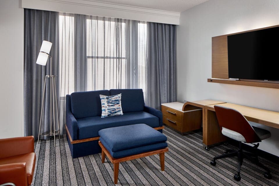 Suite, 1 King Bed with Sofa bed | Living area | 27-inch TV with cable channels, pay movies