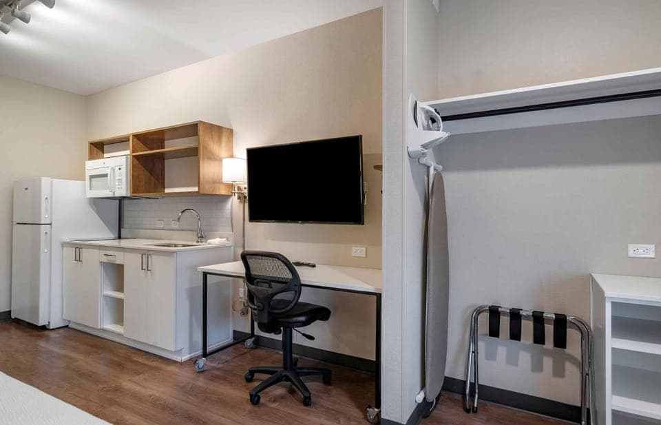 Desk, laptop workspace, blackout drapes, iron/ironing board