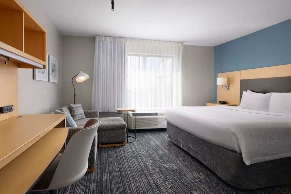 Premium bedding, laptop workspace, iron/ironing board
