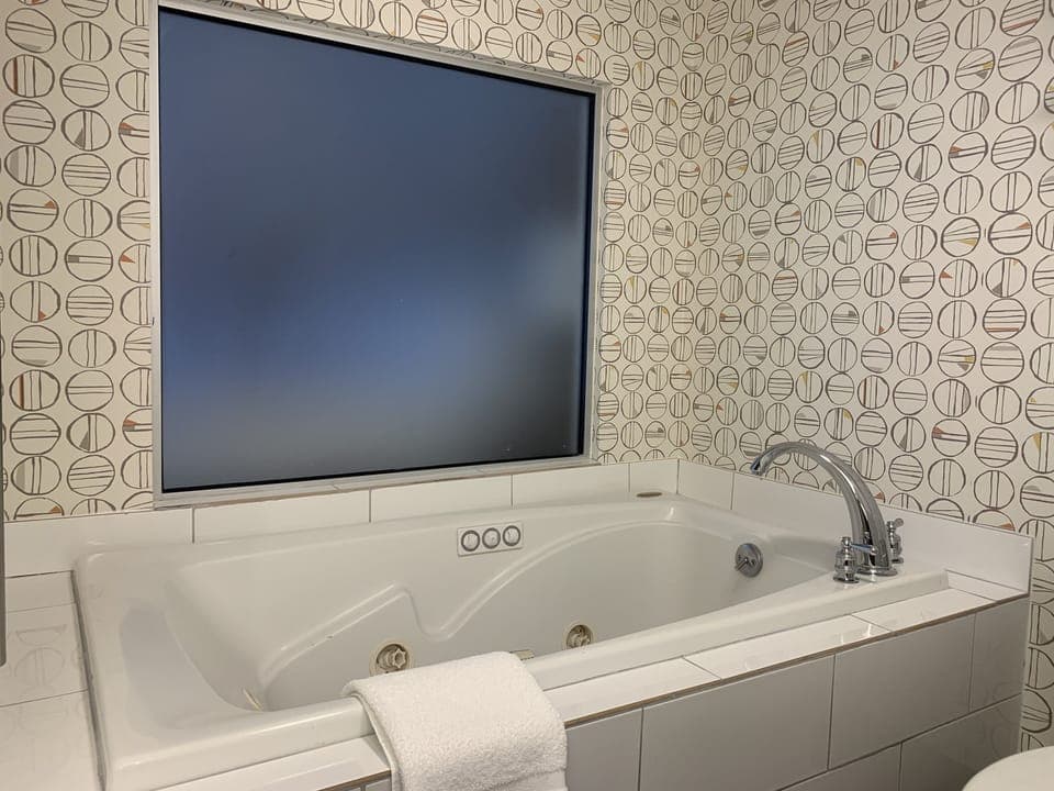 Hypo-allergenic bedding, desk, laptop workspace, blackout drapes