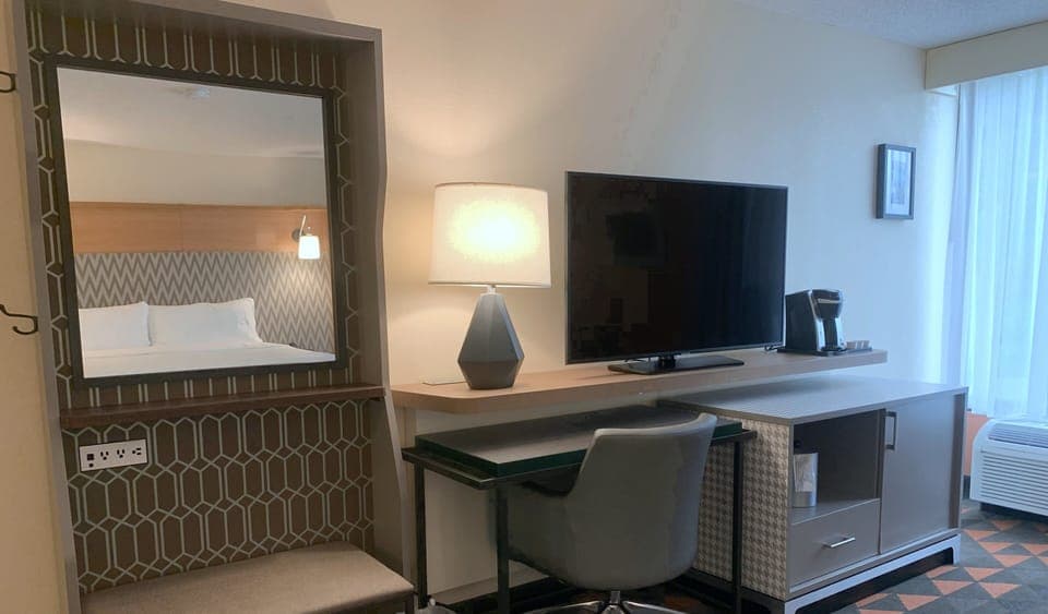 Hypo-allergenic bedding, desk, laptop workspace, blackout drapes