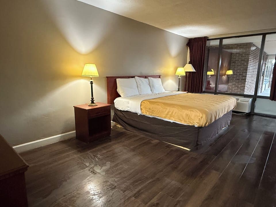 Premium bedding, desk, laptop workspace, iron/ironing board