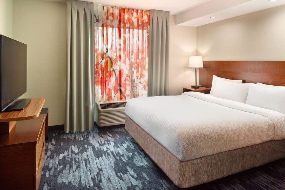 Premium bedding, desk, laptop workspace, blackout drapes