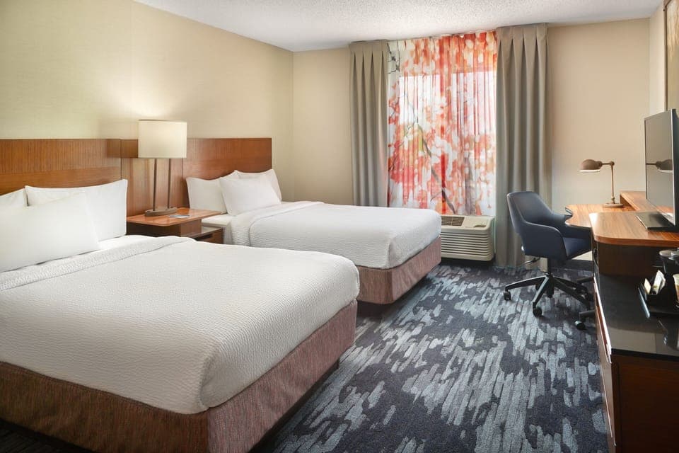 Premium bedding, desk, laptop workspace, blackout drapes