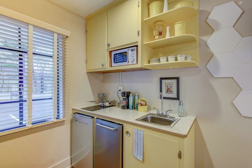 Mini-fridge, microwave, cleaning supplies, paper towels