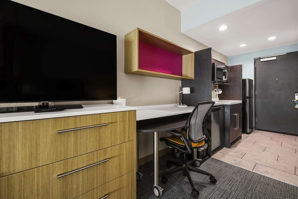 Premium bedding, desk, laptop workspace, iron/ironing board
