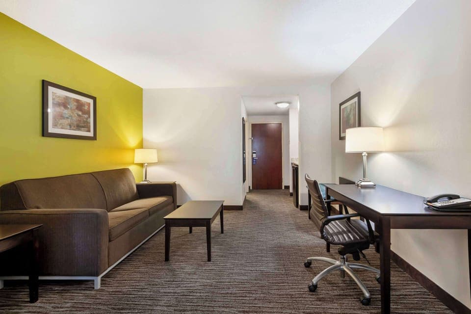 Premium bedding, desk, laptop workspace, blackout drapes
