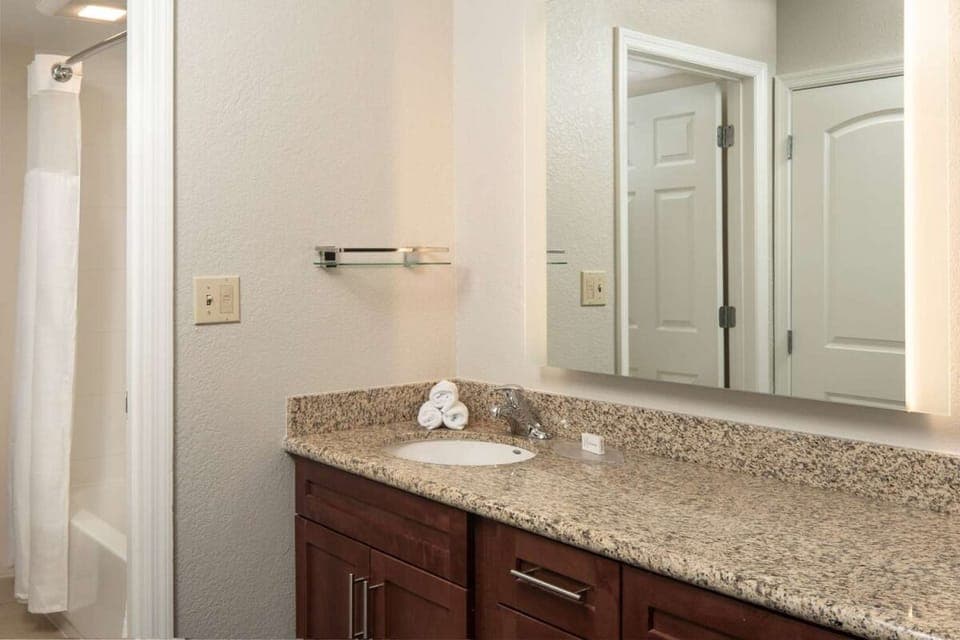 Refresh comfortably with granite vanity and bright, clean mirror light.
