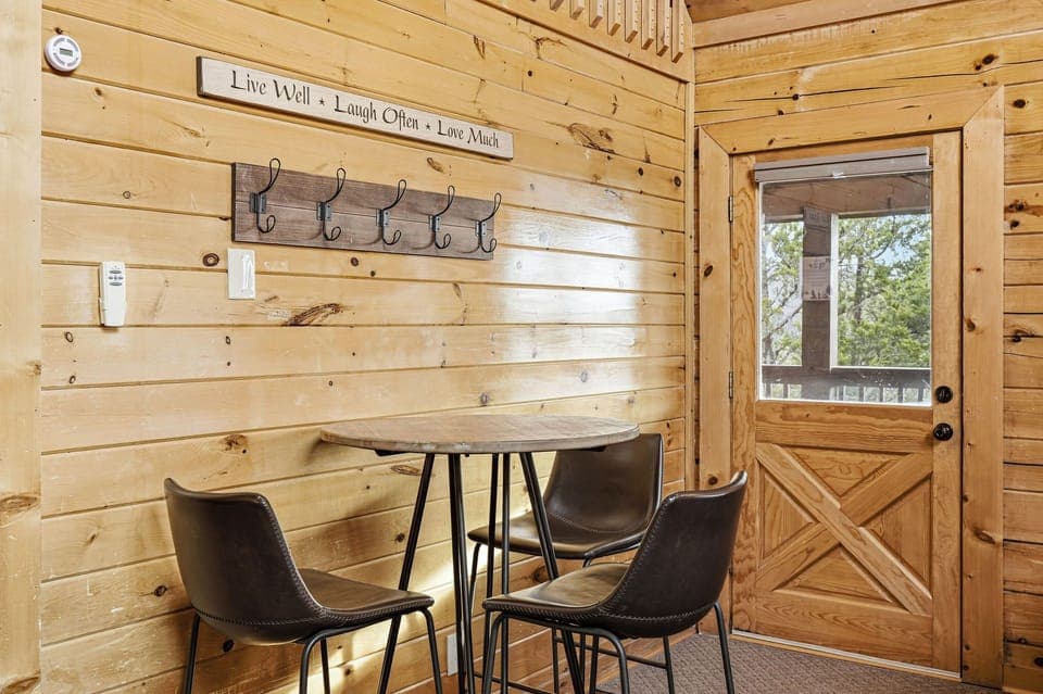 Step into your cozy dining nook with rustic charm—warm wood walls, inspiring quotes, and a perfect spot for morning coffee or evening meals.