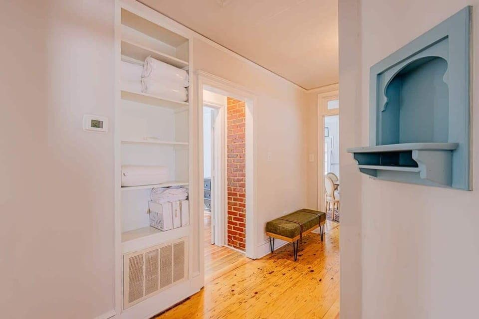 A charming hallway connecting you to a restful and inviting bedroom space.