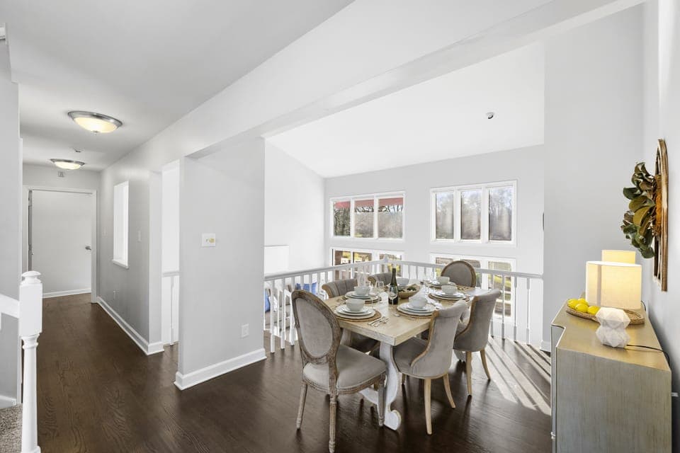 Main level dining area with seating for six, steps from the kitchen overlooking the lake.