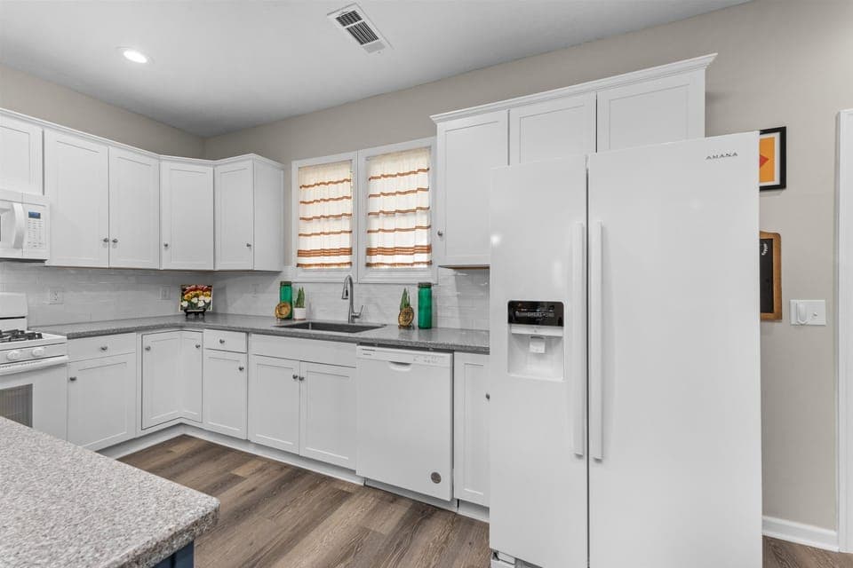Updated and fully-equipped kitchen with granite countertops.