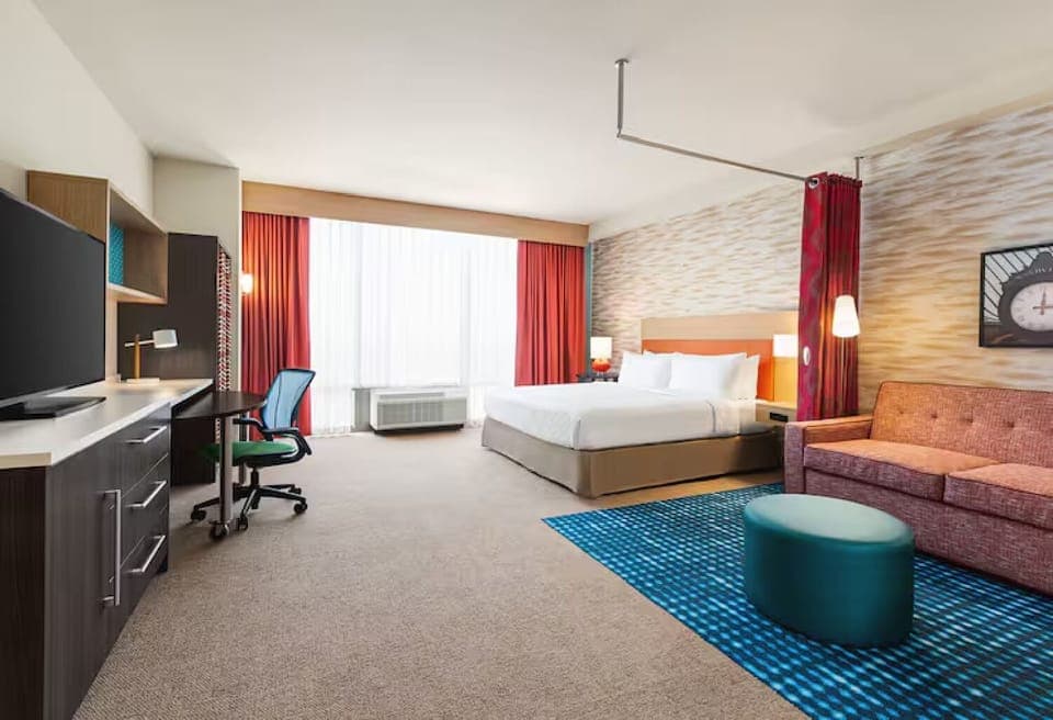 Unwind in a bright, spacious suite with plush king bed.