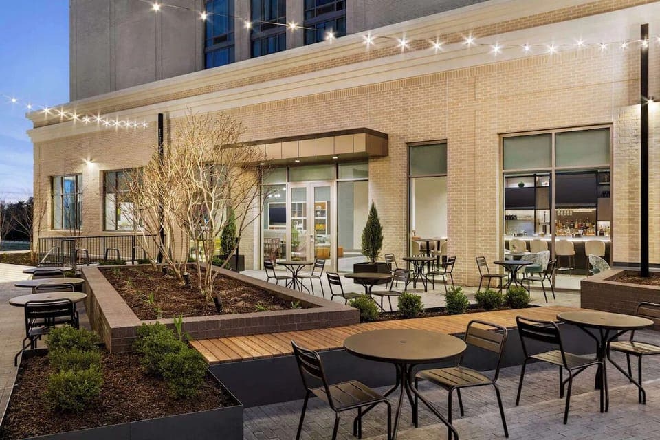 Gather with friends on the twinkling-lit courtyard patio at dusk.