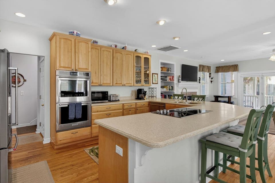 Cook together in your spacious kitchen featuring granite counters, stainless appliances, and a breakfast bar perfect for morning coffee chats.