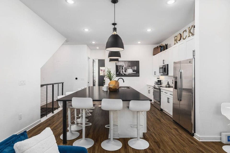 Huge kitchen on the main floor of the house with  a massive island, seating for 10, and all the appliances / supplies you'd need to cook a meal.