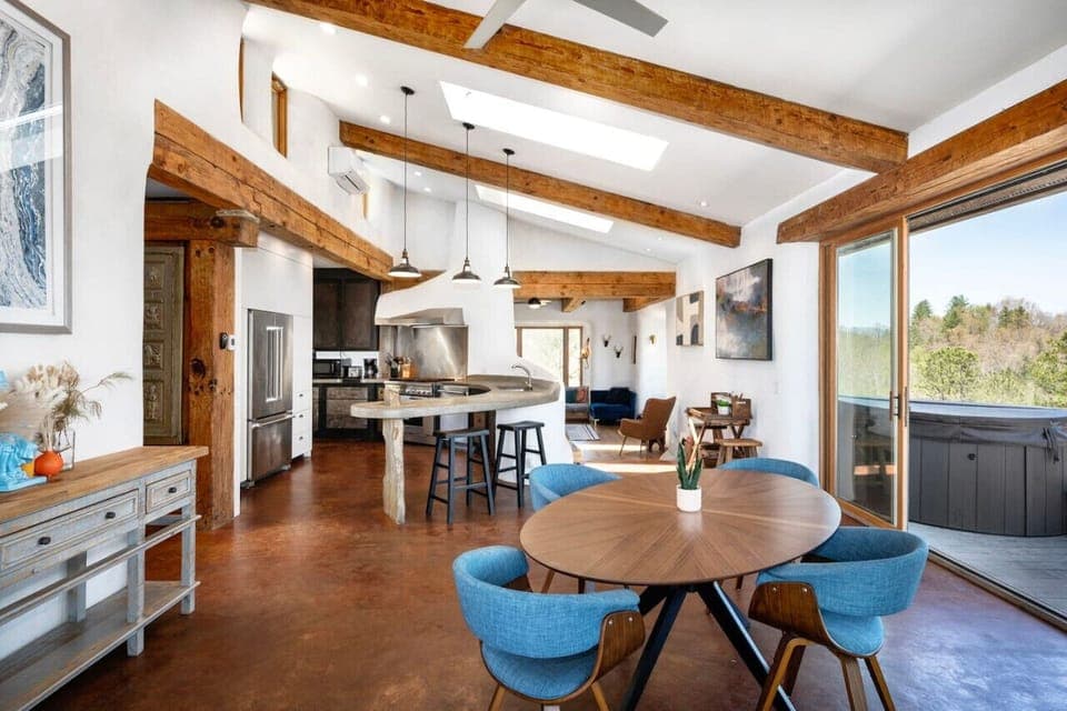 Main home is open and airy with massive wrap-around deck and skylights in vaulted ceiling