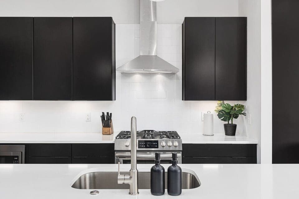 Fully-stocked chef's kitchen with a gas range, wet bar, seating for four at the island, and all the appliances / tools you could need to cook and enjoy a meal together.