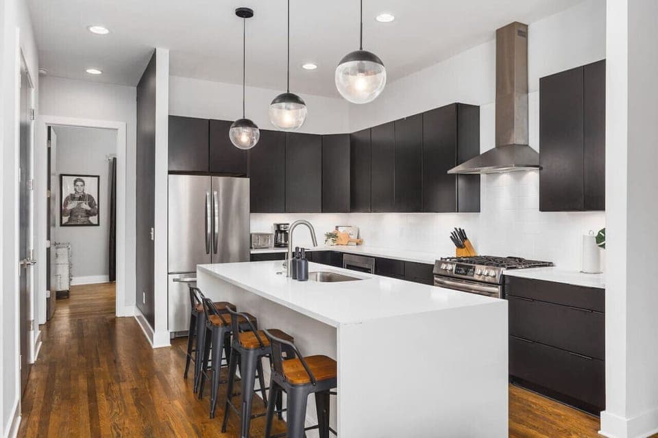 Fully-stocked chef's kitchen with a gas range, wet bar, seating for four at the island, and all the appliances / tools you could need to cook and enjoy a meal together.