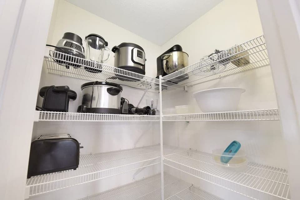 well-organized pantry shelves with various kitchen appliances for convenient cooking