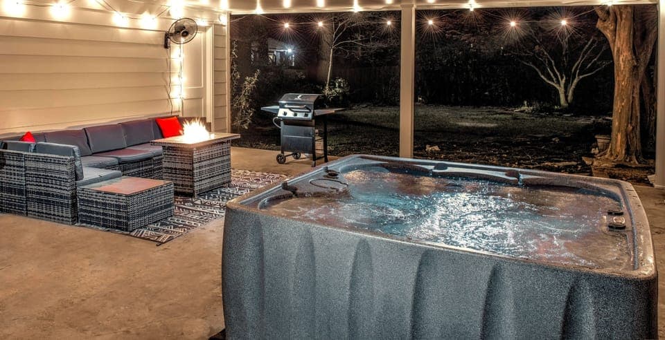 Hot tub and outdoor seating area. Grill included.