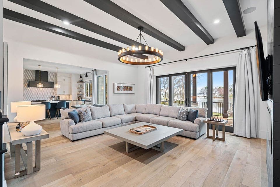 Large section in living room with plenty of seating options and access to the deck.