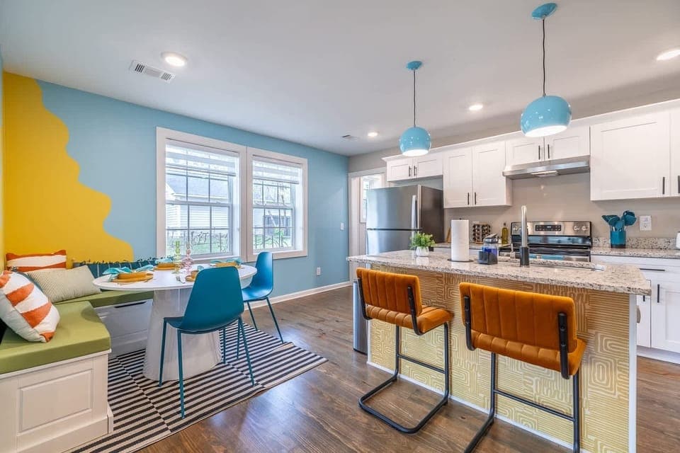Step into our elegantly appointed dining area, seamlessly connected to a fully equipped kitchen featuring a spacious kitchen island. This thoughtfully designed space not only invites culinary exploration but also serves as the heart of the home, where meals and memories are made in comfort and style.