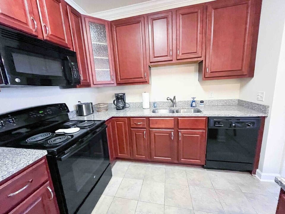 Kitchen with dishwasher, stainless steel pots and pans and seasoning to cook at home 