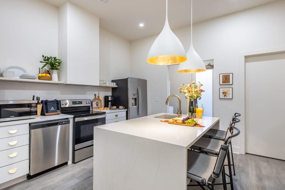 Kitchen features modern stainless-steel appliances.
