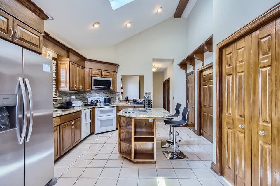 Enjoy the full kitchen with filtered water, refrigerator, freezer, oven, stove, microwave, dishwasher, coffee, creamers, mixers, spices, pots, pans, cooking supplies, cutlery, cups, plates, bowls, utensils, small appliances, and many more essentials!