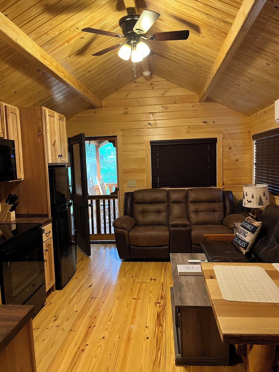 Main living area which includes 2 rocker/recliners, and a 3 seat/full bed futon 