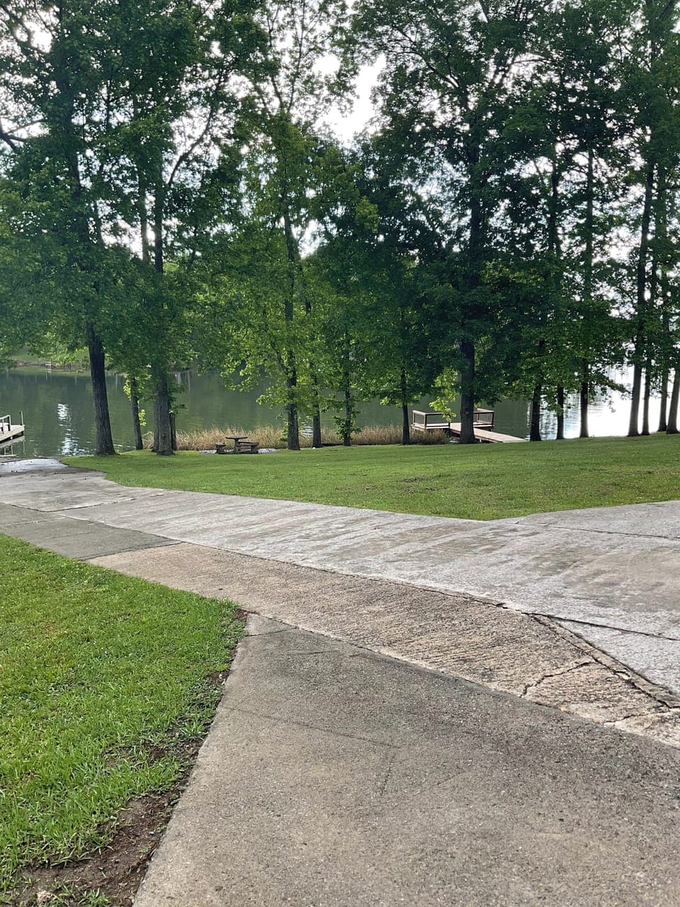 Driveway leads to boat ramp, parking for boat trailer to right of driveway 