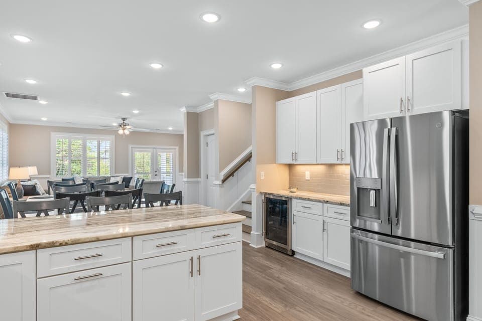 Your fully equipped kitchen features white cabinetry, granite counters, and stainless steel appliances, perfect for preparing home-cooked meals.