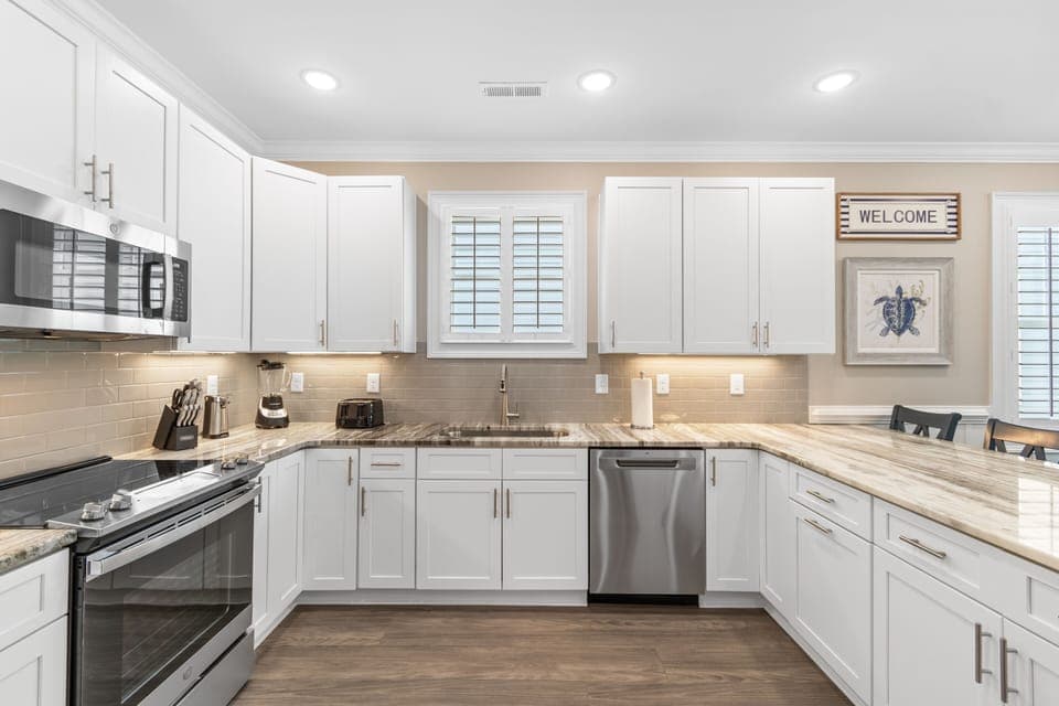 You'll love cooking in this bright, fully-equipped kitchen with modern appliances, granite counters, and plenty of cabinet space for all your vacation needs.